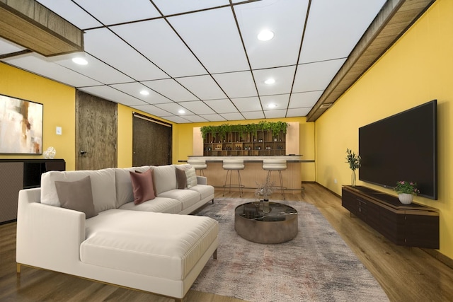 living room featuring bar and hardwood / wood-style floors