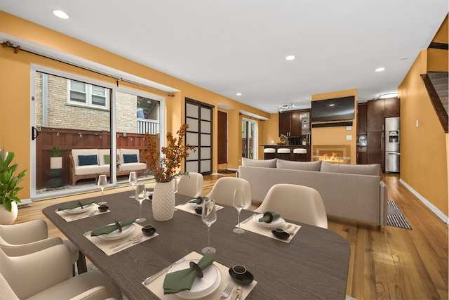 dining space featuring plenty of natural light and light wood-type flooring