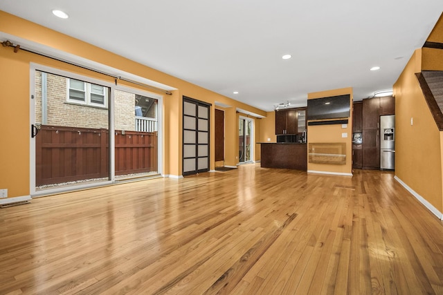 unfurnished living room with light wood-type flooring