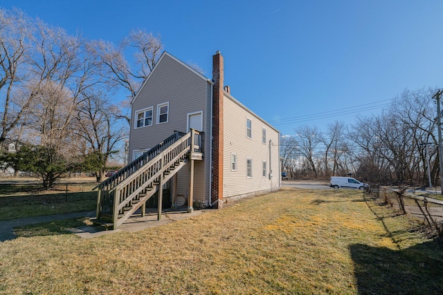 view of side of property featuring a yard