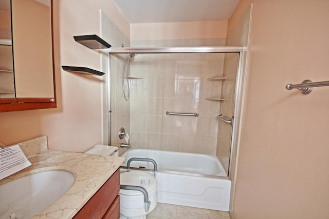 full bathroom featuring enclosed tub / shower combo, vanity, toilet, and tile patterned floors