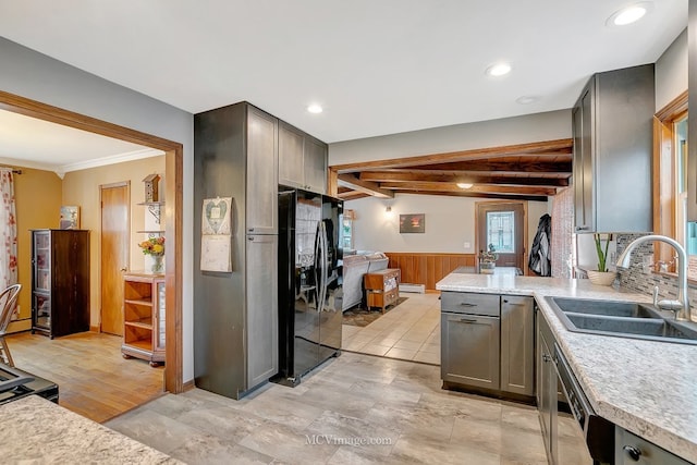 kitchen featuring sink, dishwasher, beam ceiling, ornamental molding, and black fridge with ice dispenser