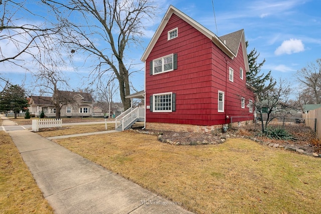 view of side of home featuring a yard