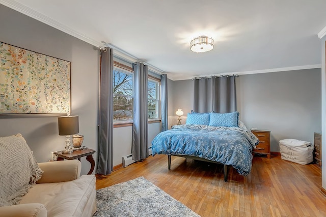 bedroom with crown molding and light wood-type flooring