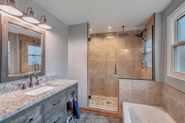 bathroom featuring vanity and separate shower and tub