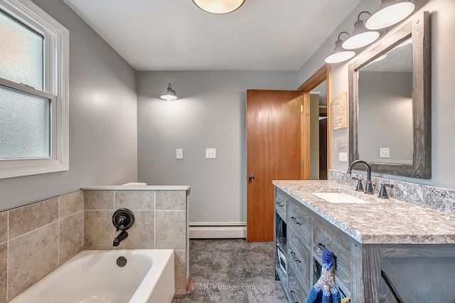 bathroom with a baseboard radiator, vanity, and a bathing tub