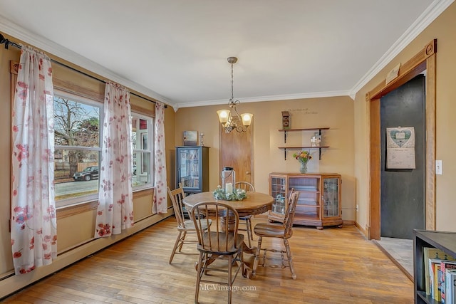 dining space featuring a baseboard radiator, ornamental molding, a notable chandelier, and light wood-type flooring