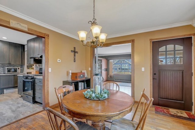 dining space featuring a notable chandelier, light hardwood / wood-style flooring, ornamental molding, and baseboard heating