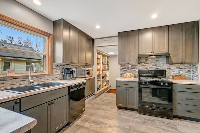 kitchen featuring sink, decorative backsplash, and black appliances