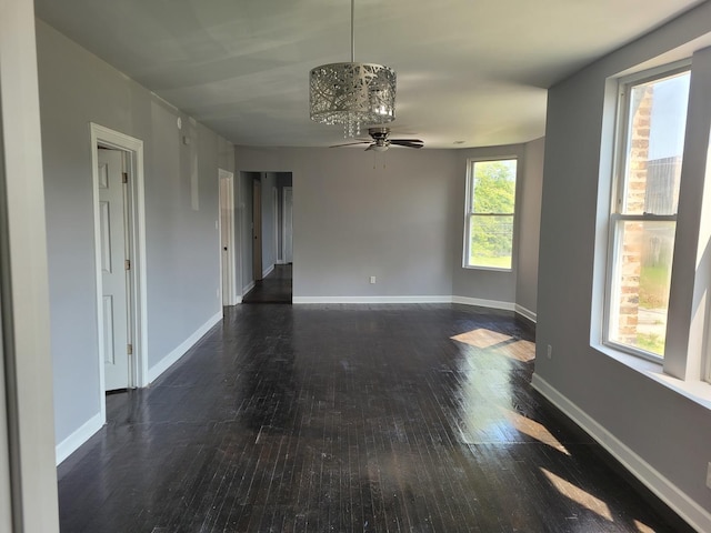 spare room with dark wood-type flooring and ceiling fan