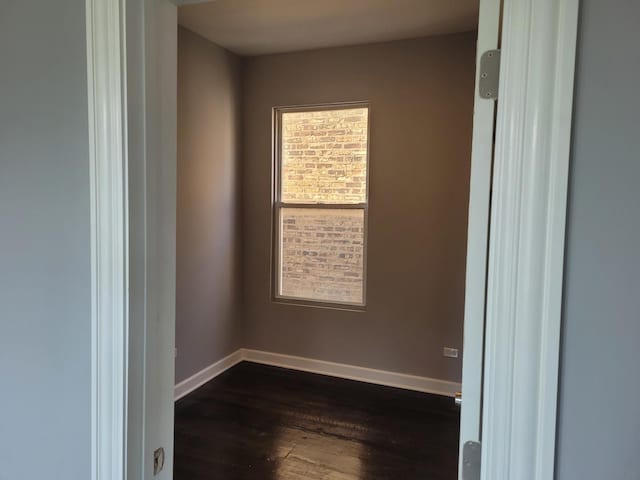 spare room featuring dark hardwood / wood-style floors and a wealth of natural light