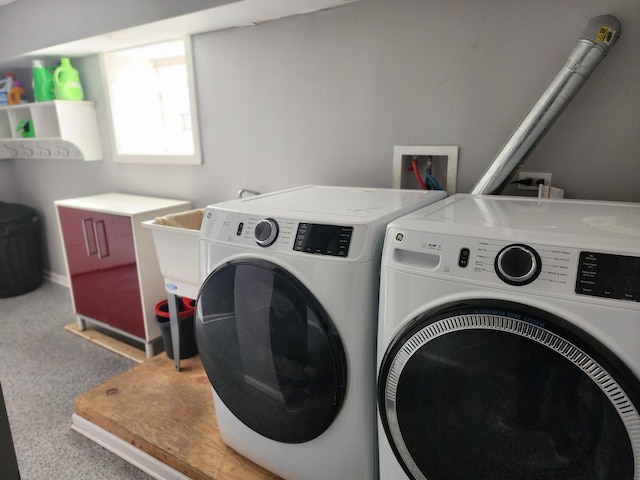 laundry area featuring washing machine and dryer and carpet floors