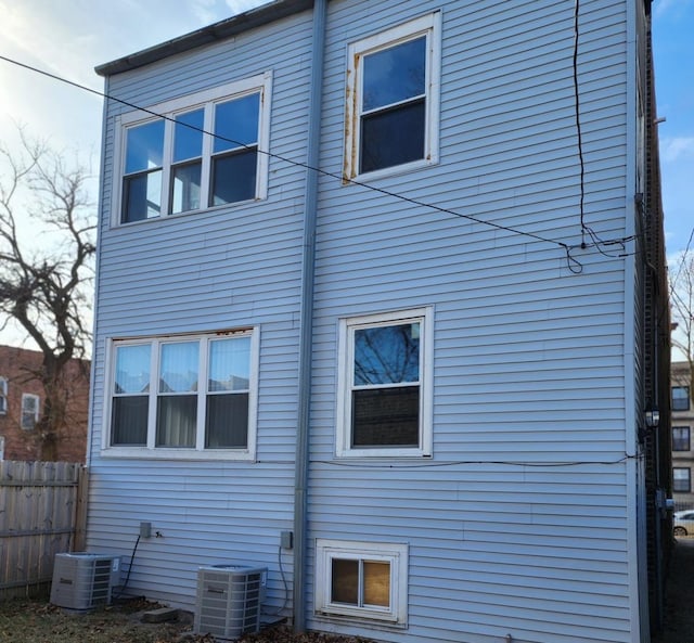 rear view of property featuring central AC unit