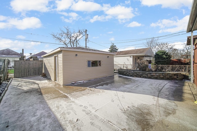 back of property featuring an outbuilding