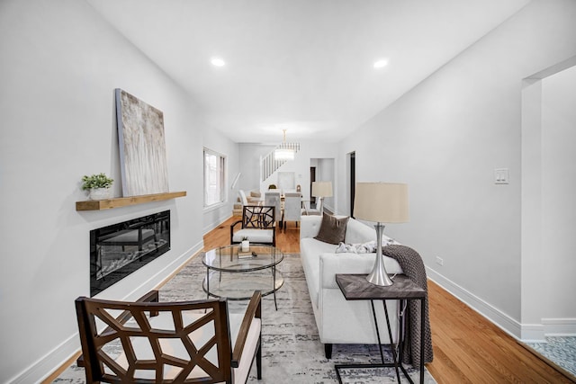 living room with a notable chandelier and wood-type flooring