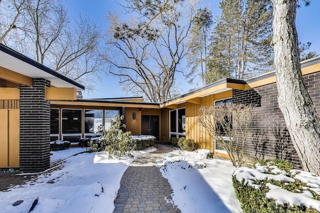 exterior space featuring brick siding