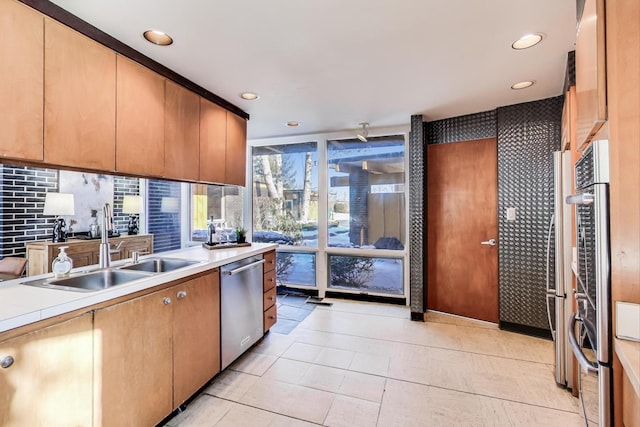 kitchen featuring light tile patterned flooring, a sink, light countertops, stainless steel dishwasher, and tasteful backsplash