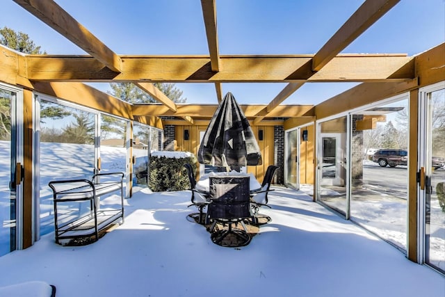 snow covered patio featuring outdoor dining area