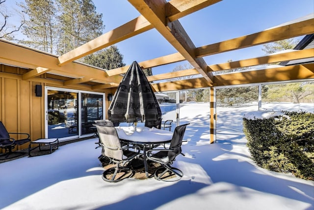 snow covered patio featuring outdoor dining space