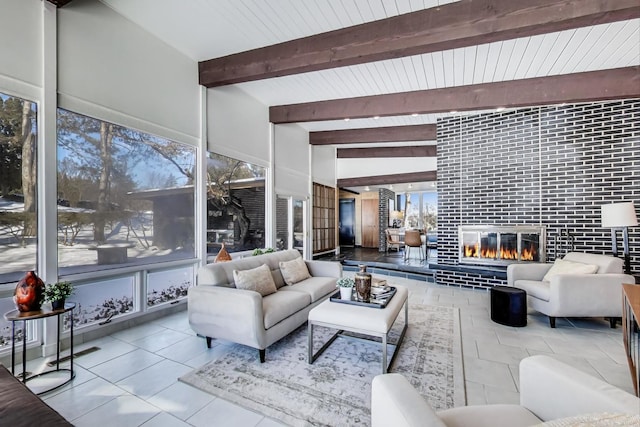 living room with light tile patterned floors, a fireplace, visible vents, and beamed ceiling