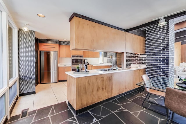 kitchen with visible vents, a peninsula, stainless steel appliances, light countertops, and recessed lighting