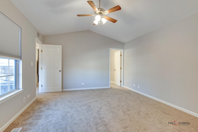 unfurnished bedroom with lofted ceiling, light colored carpet, and ceiling fan