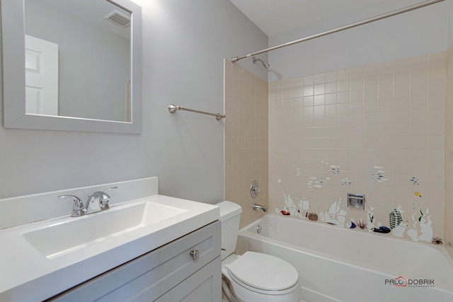 full bathroom with vanity, tiled shower / bath, and toilet