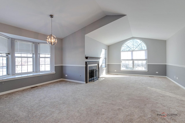 unfurnished living room featuring light colored carpet, vaulted ceiling, and a notable chandelier