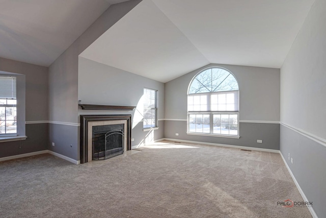 unfurnished living room featuring light carpet and vaulted ceiling