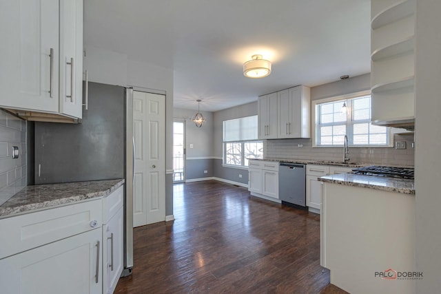 kitchen featuring stainless steel dishwasher, dark hardwood / wood-style floors, sink, and white cabinets