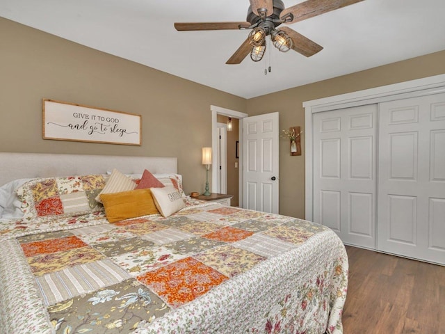 bedroom featuring dark wood-type flooring, ceiling fan, and a closet