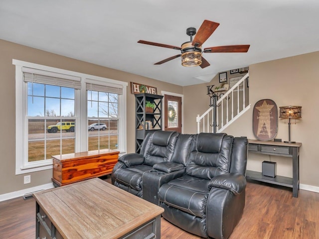 living room with dark wood-type flooring and ceiling fan