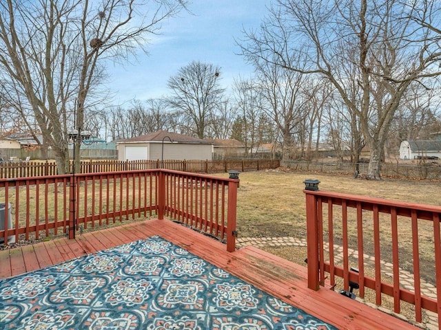 wooden deck with a yard and a garage