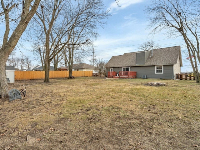 view of yard with a wooden deck and central air condition unit