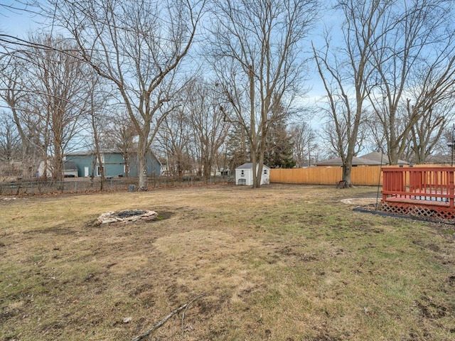 view of yard with a wooden deck and a shed