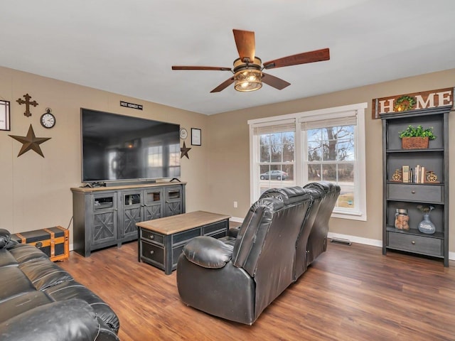 living room with ceiling fan and dark hardwood / wood-style flooring