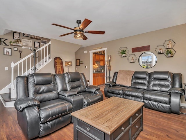 living room featuring dark wood-type flooring and ceiling fan