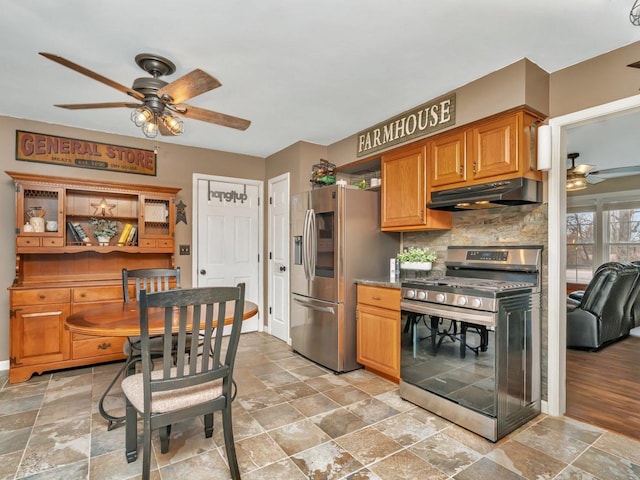 kitchen with ceiling fan, stainless steel appliances, and backsplash