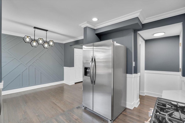 kitchen featuring crown molding, dark wood-type flooring, stainless steel fridge, and decorative light fixtures