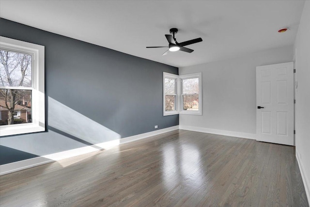 spare room with ceiling fan and dark hardwood / wood-style floors