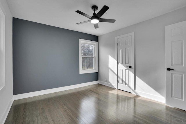 unfurnished room featuring dark wood-type flooring and ceiling fan