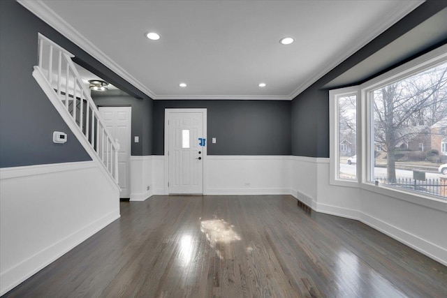 foyer with ornamental molding and dark wood-type flooring