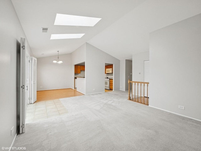 empty room with light carpet, a skylight, baseboards, visible vents, and a chandelier