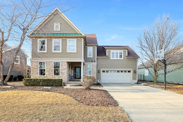 view of front of house featuring stone siding, a front lawn, an attached garage, and driveway