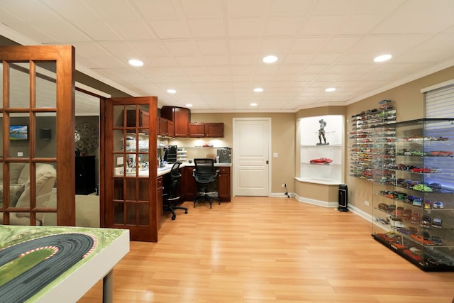 office space featuring light wood-type flooring, baseboards, crown molding, and recessed lighting