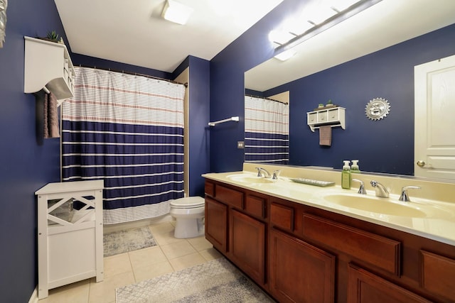 bathroom featuring tile patterned flooring, a sink, toilet, and double vanity