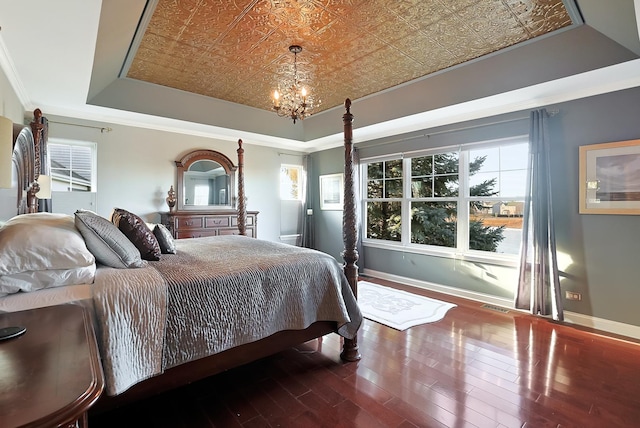 bedroom featuring visible vents, baseboards, a tray ceiling, an ornate ceiling, and crown molding