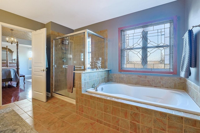 full bathroom featuring a stall shower, connected bathroom, tile patterned floors, a garden tub, and a notable chandelier