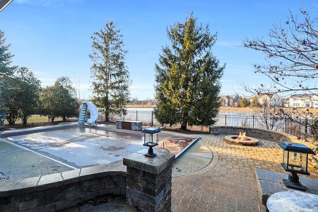 exterior space featuring an outdoor fire pit and a fenced backyard