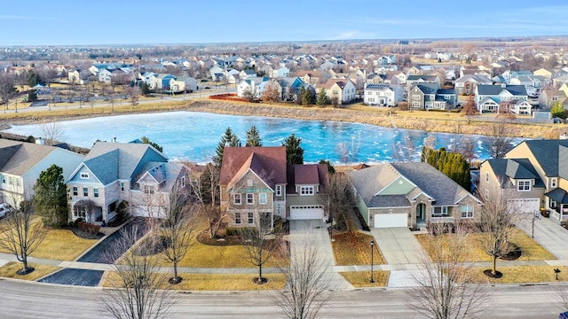 drone / aerial view with a water view and a residential view